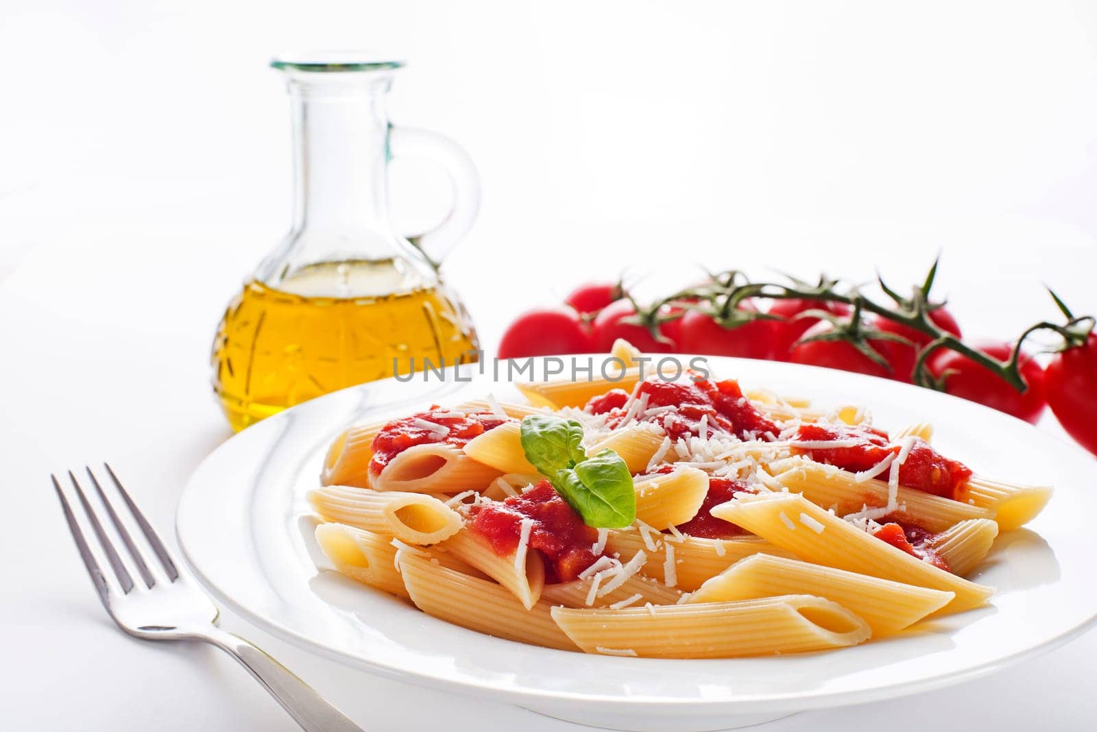 Plate of penne pasta with tomato sauce and parmesan cheese.