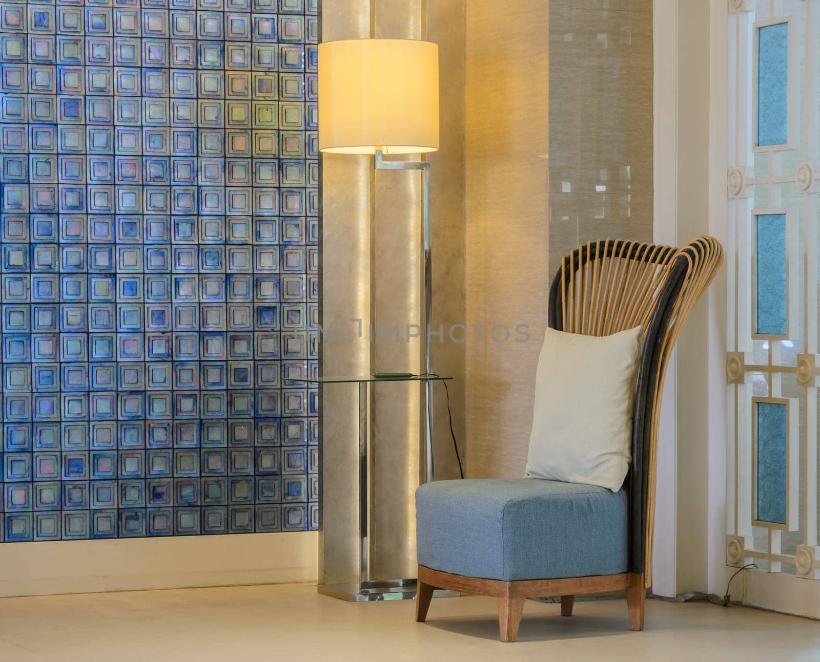 Chair with pillow and lamp at room corner