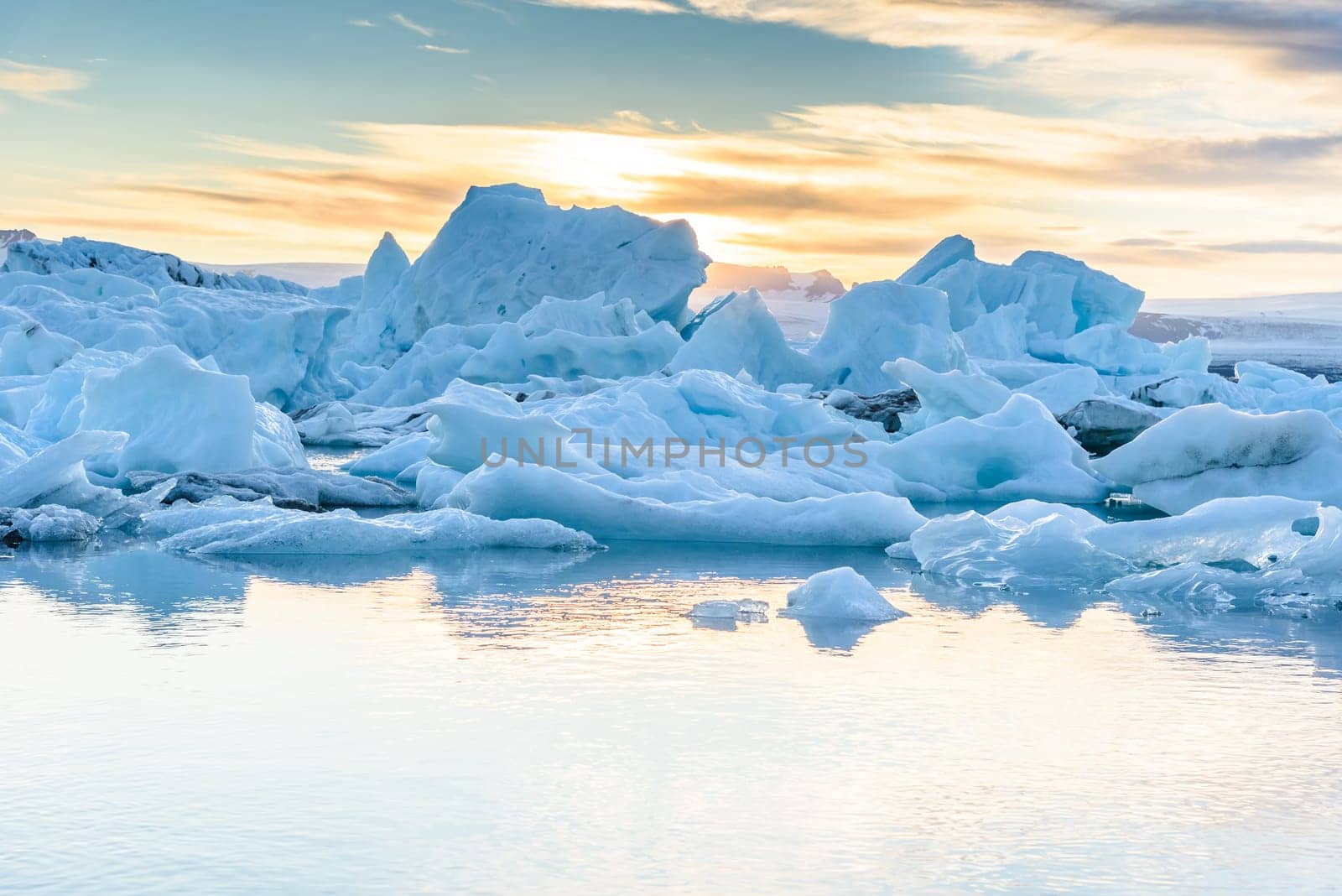 Beautiful view of icebergs in Jokulsarlon glacier lagoon at sunset, Iceland, selective focus, global warming and climate change concept
