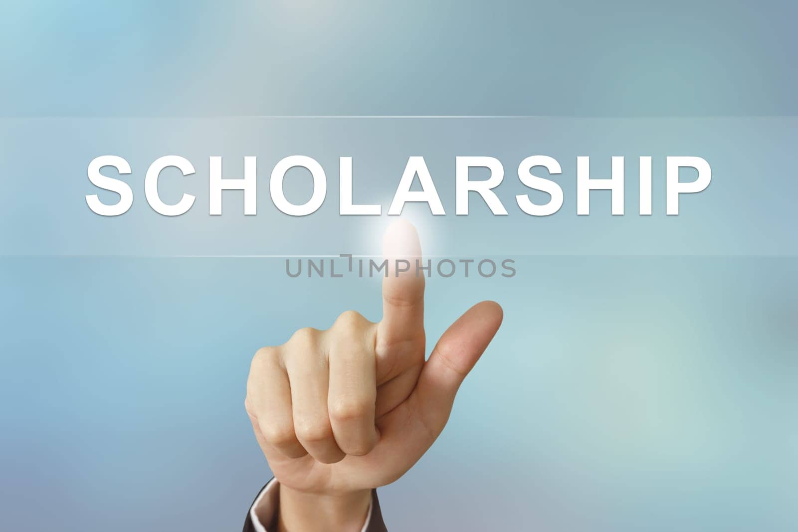 business hand pushing scholarship button on blurred background
