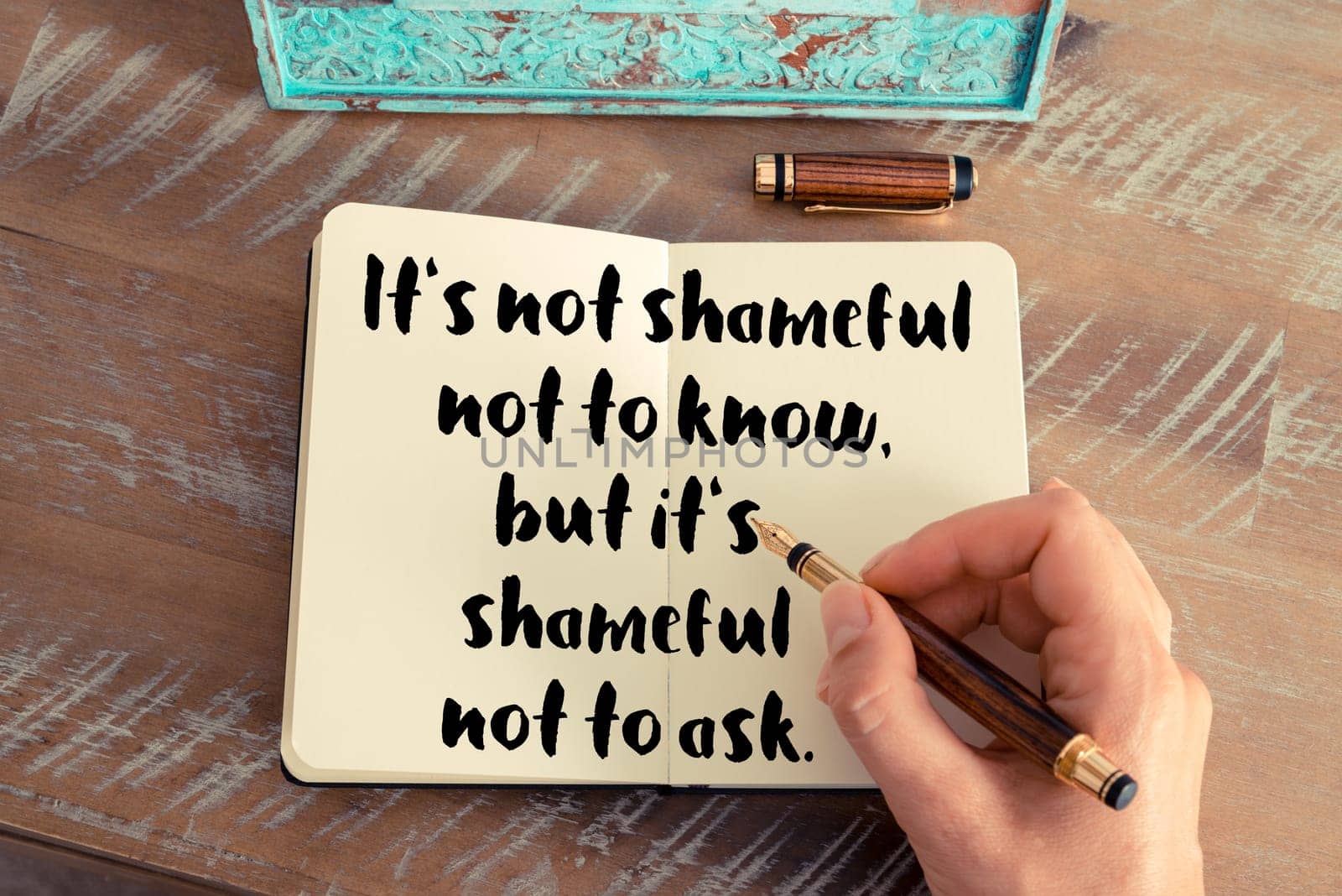 Retro effect and toned image of a woman hand writing on a notebook. Handwritten quote It&#39 s not shameful not to know, but it&#39 s shameful not to ask as inspirational concept image