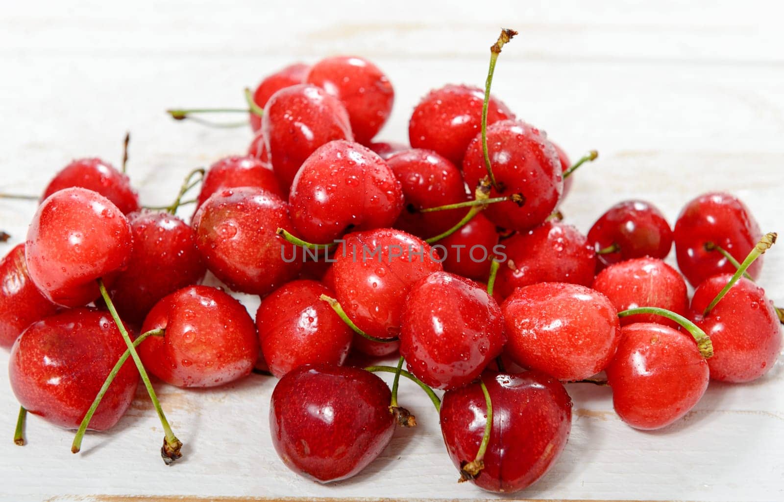 fresh cherries on white wooden table