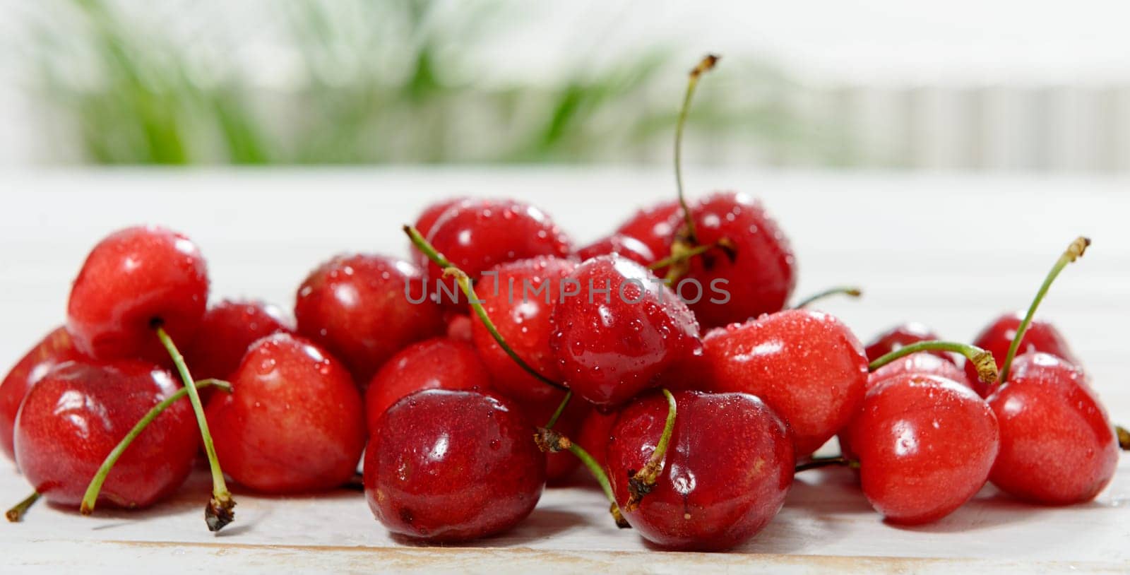 fresh cherries on white wooden table