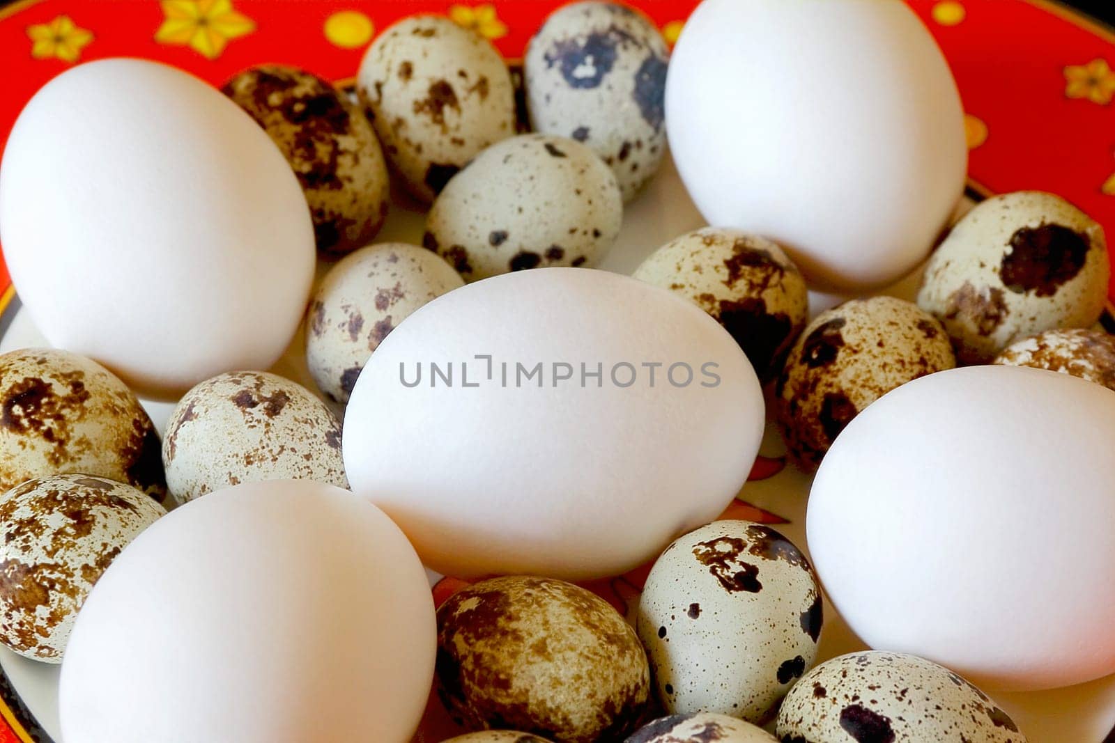 Image of red dish with hen and quail eggs