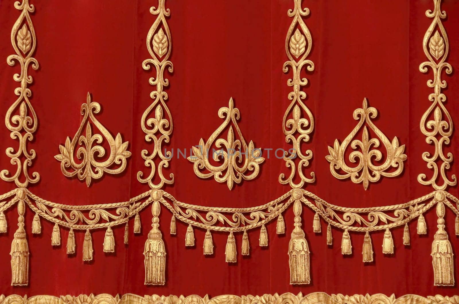 Theatrical red velvet curtain with gold pattern