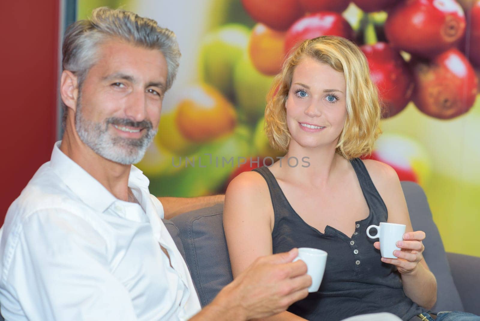 Portrait of man and lady holding cups