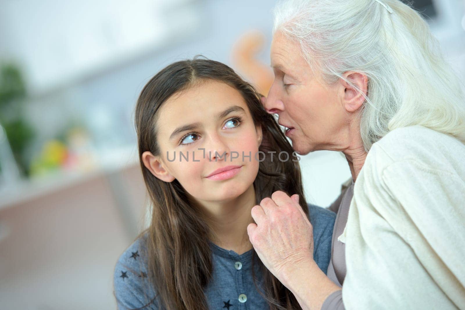Little girl and grandma whispering secrets