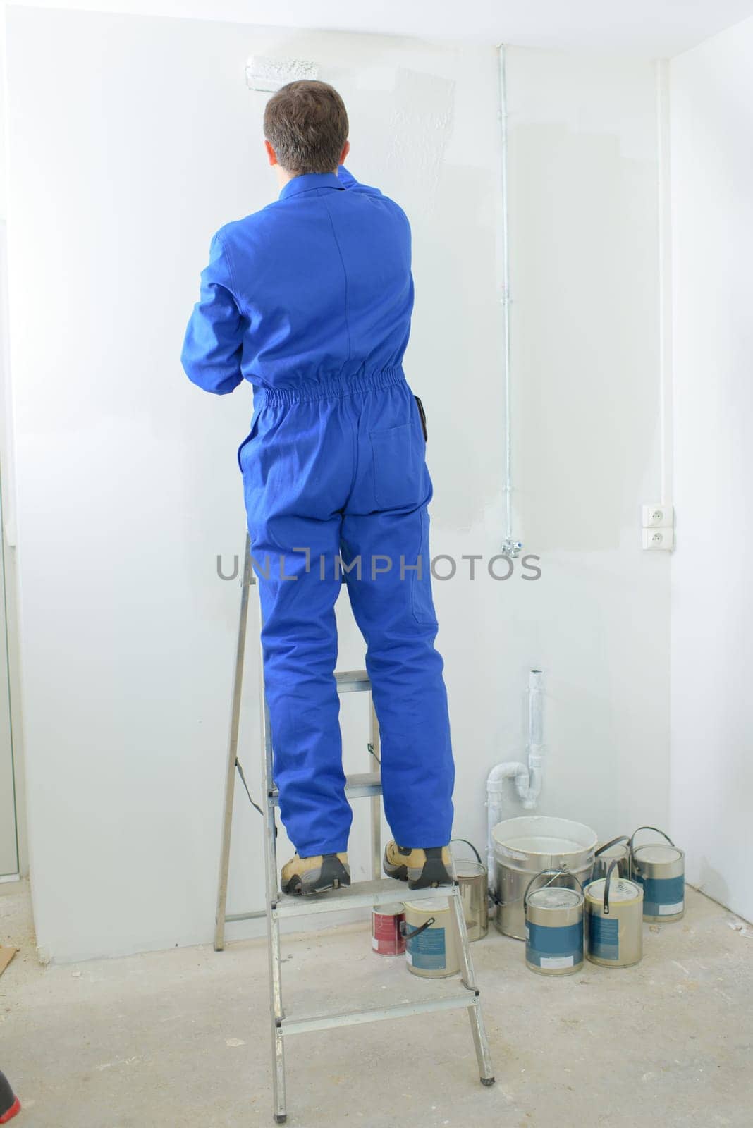 Decorator stood up a ladder