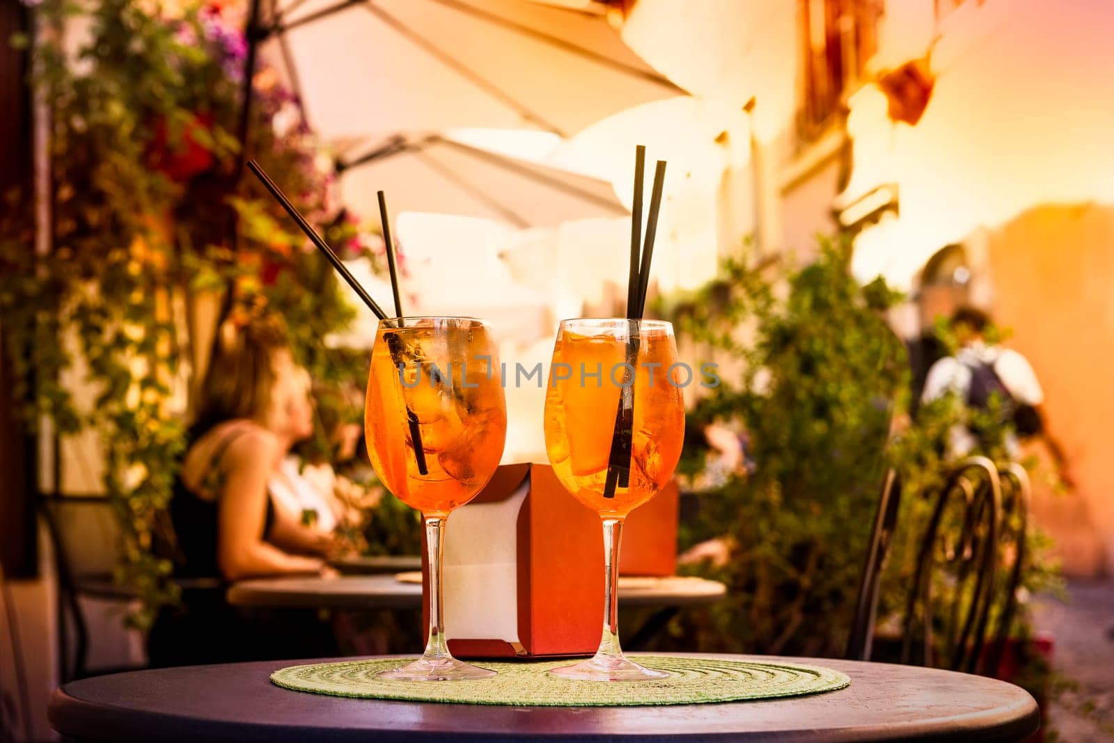 Aperol Spritz Cocktail. Alcoholic beverage based on table with ice cubes and oranges.