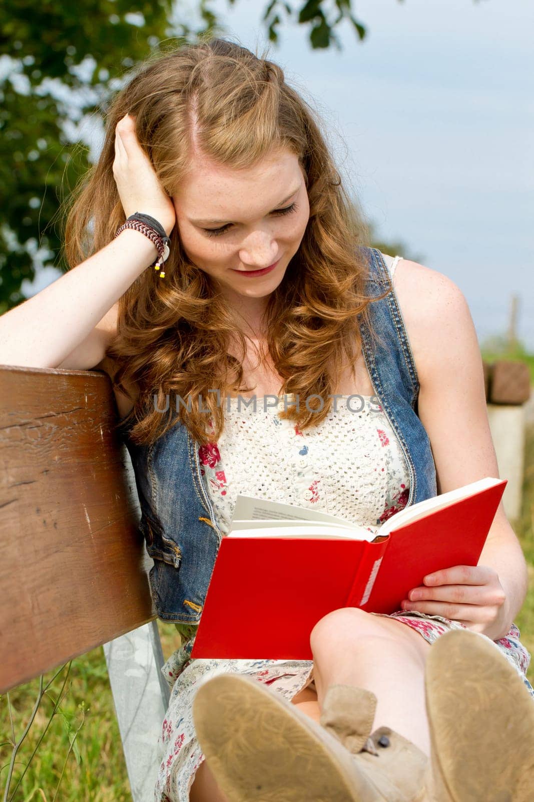 Young woman with book in nature