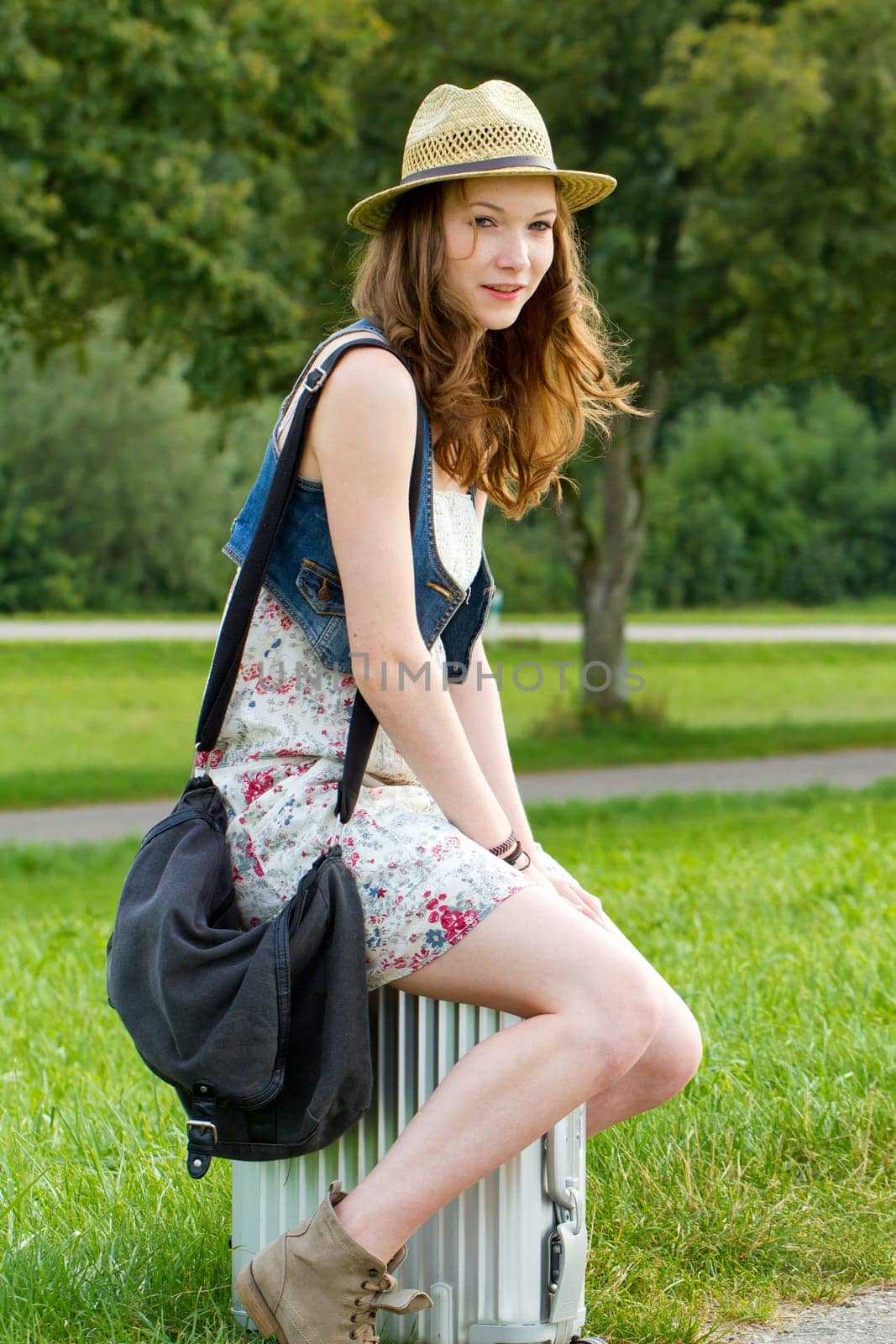 Girl with suitcase waiting for departure