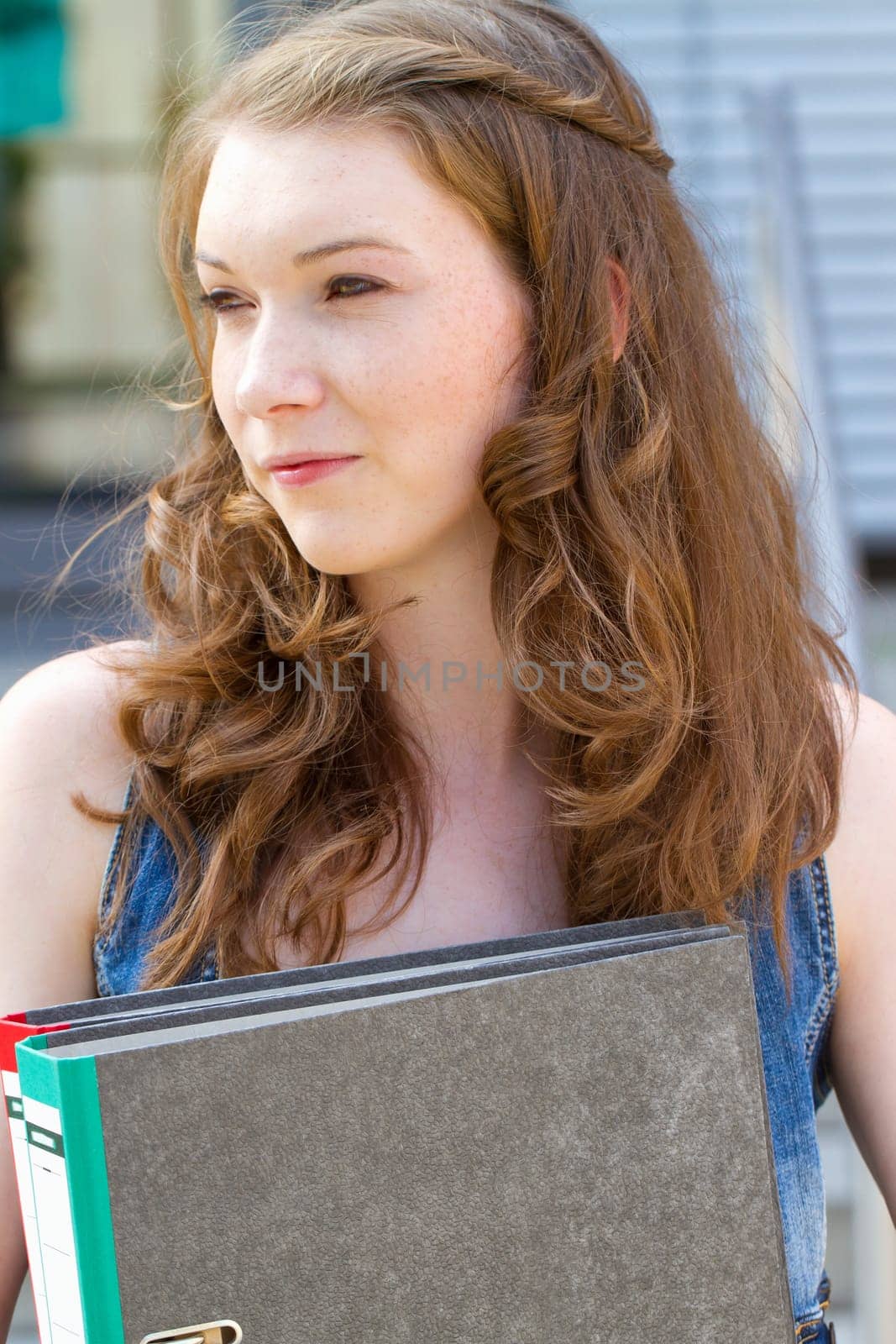 Young woman with folder in hand