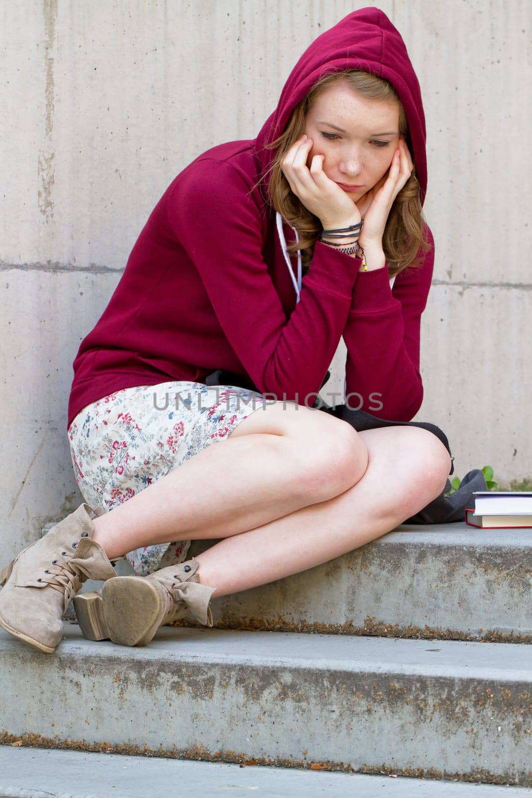 Sad schoolgirl on a staircase