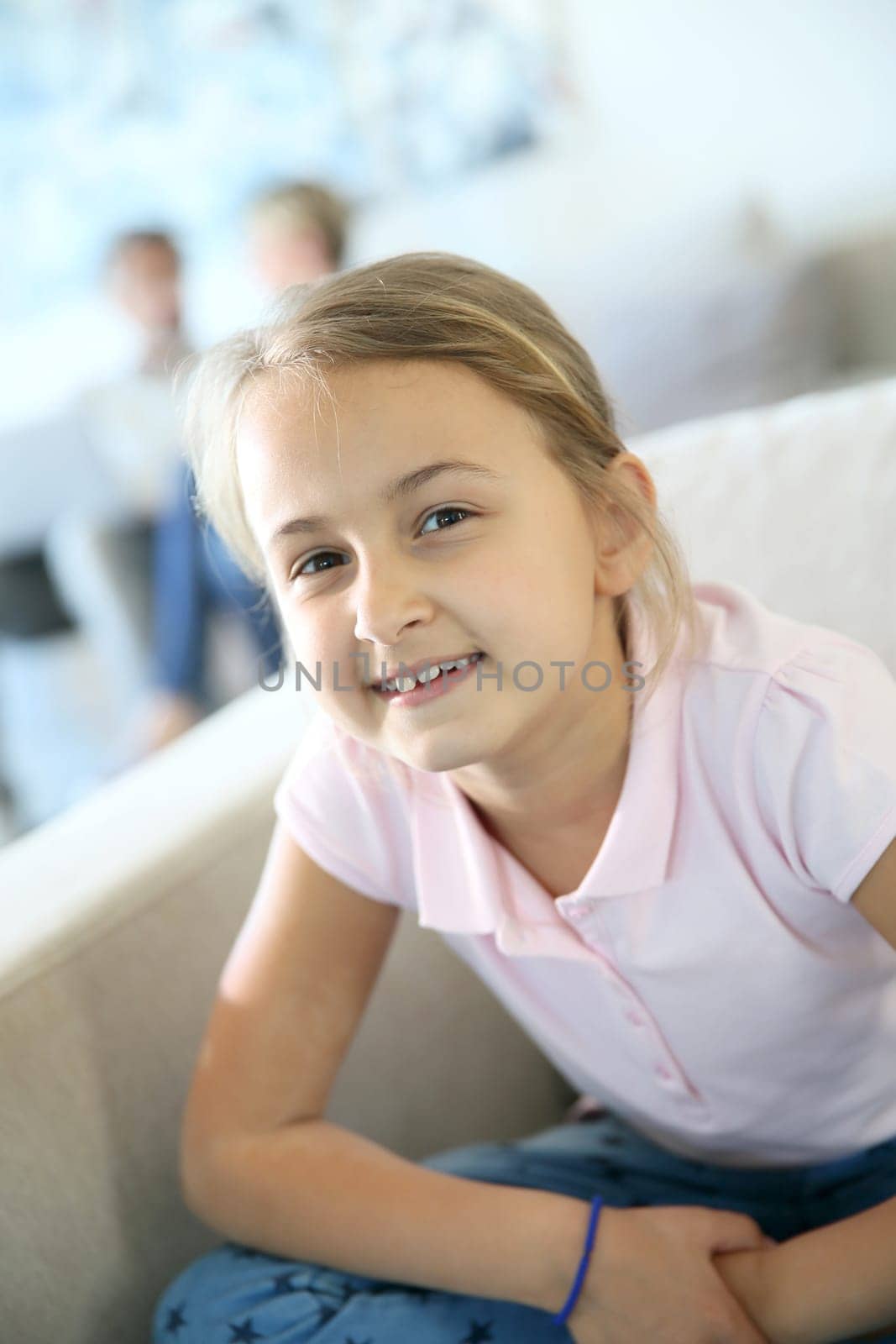 Portrait of 8-year-old girl sitting in sofa