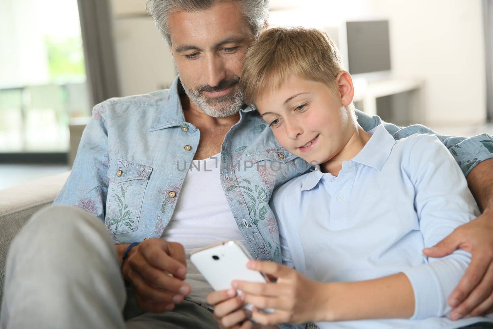 Daddy with son playing with smartphone