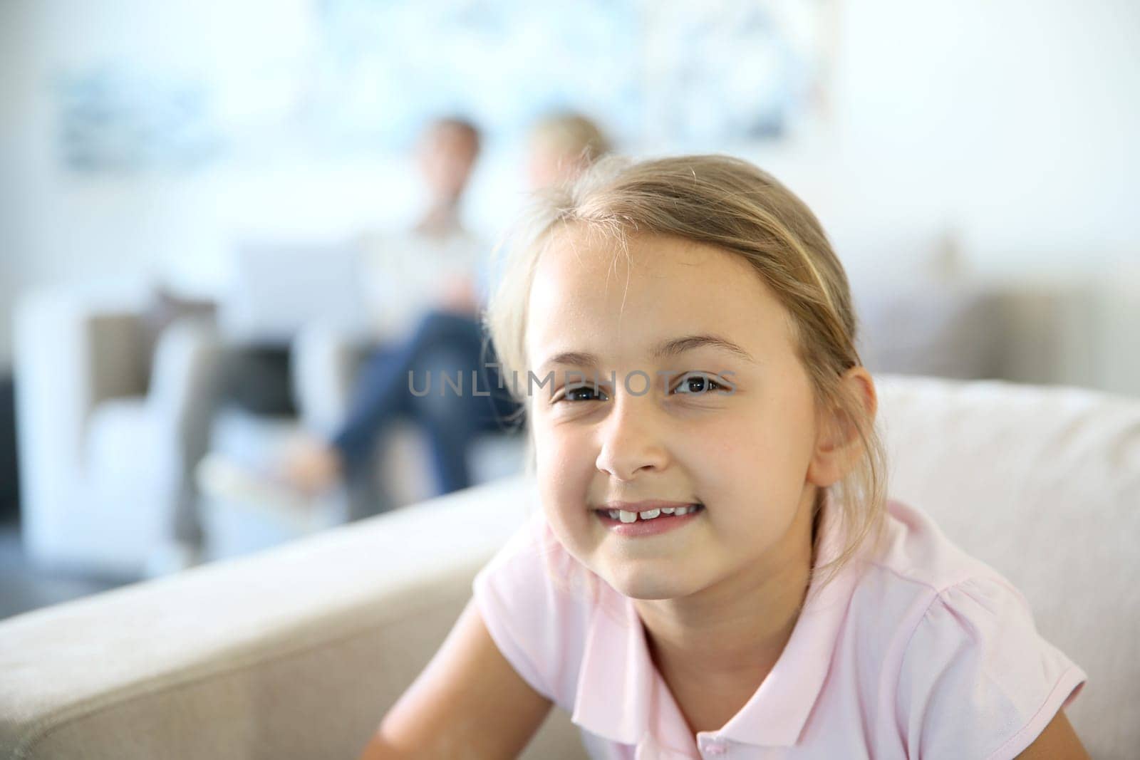 Portrait of 8-year-old girl sitting in sofa