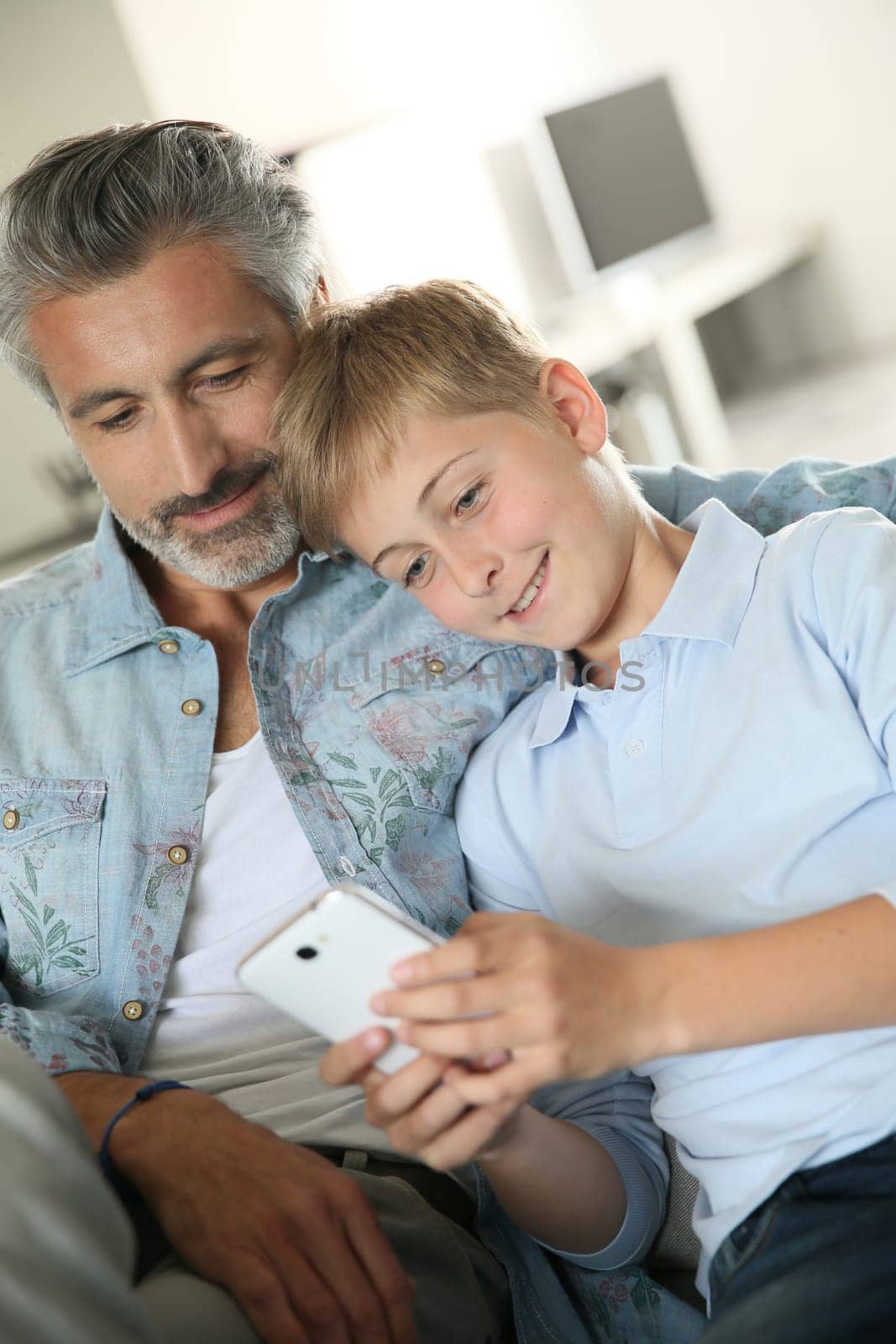Daddy with son playing with smartphone
