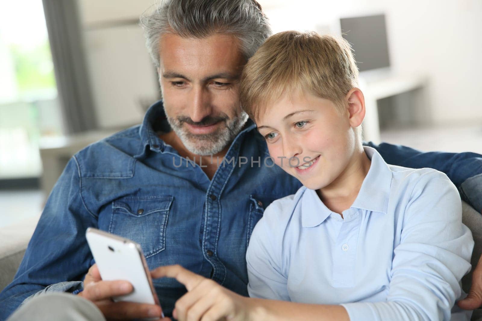 Daddy with son playing with smartphone
