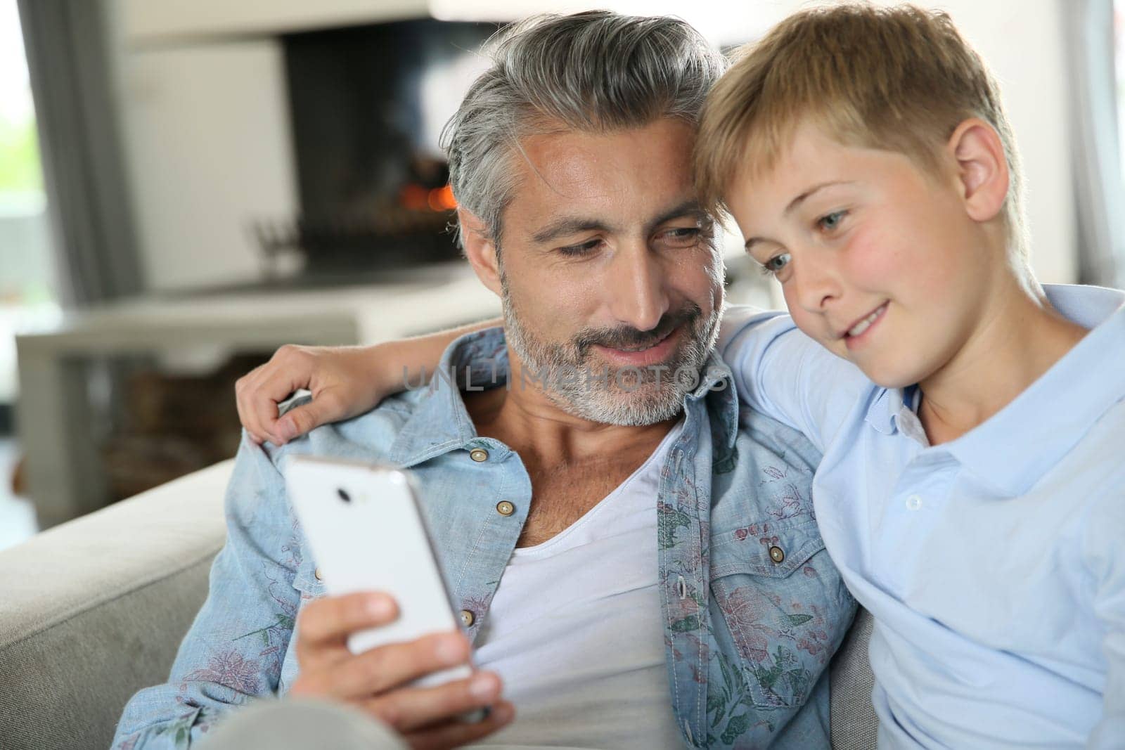 Daddy with son playing with smartphone