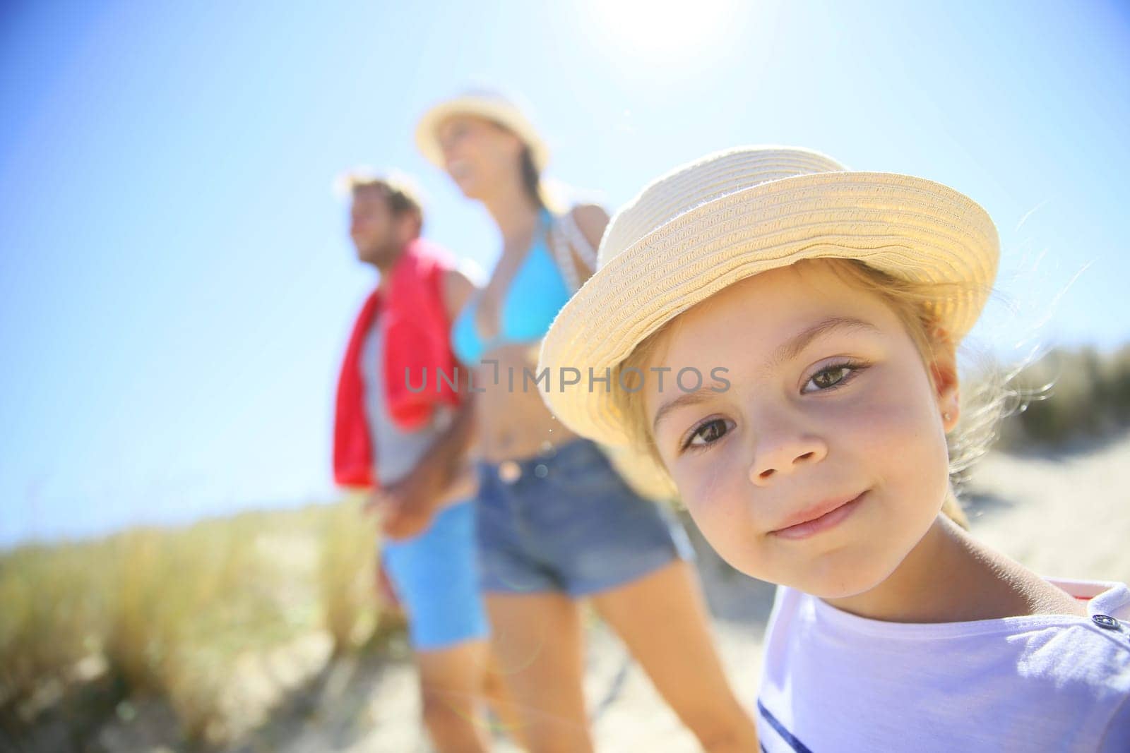 Family walking to the beach on a sunny day