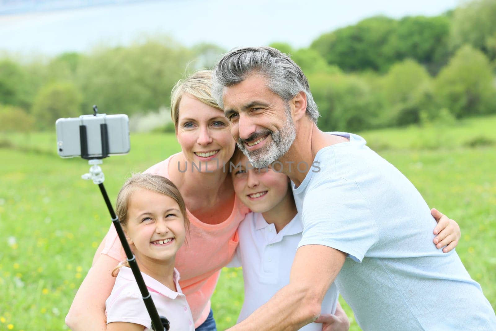 Family in vacation taking selfie picture with smartphone