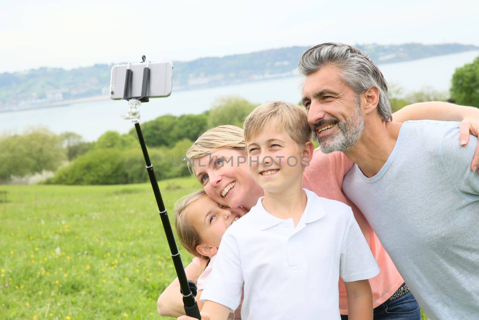 Family in vacation taking selfie picture with smartphone