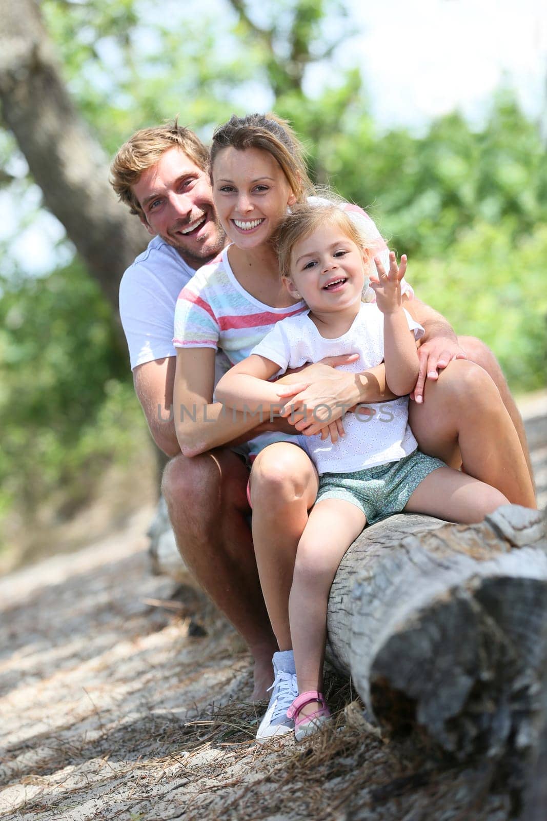 portrait of happy family sitting on a trunk