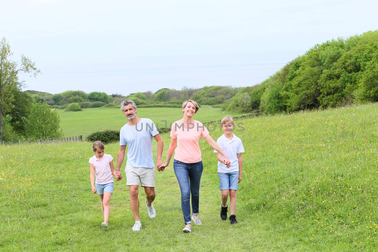 Family walking on country trail during vacation time