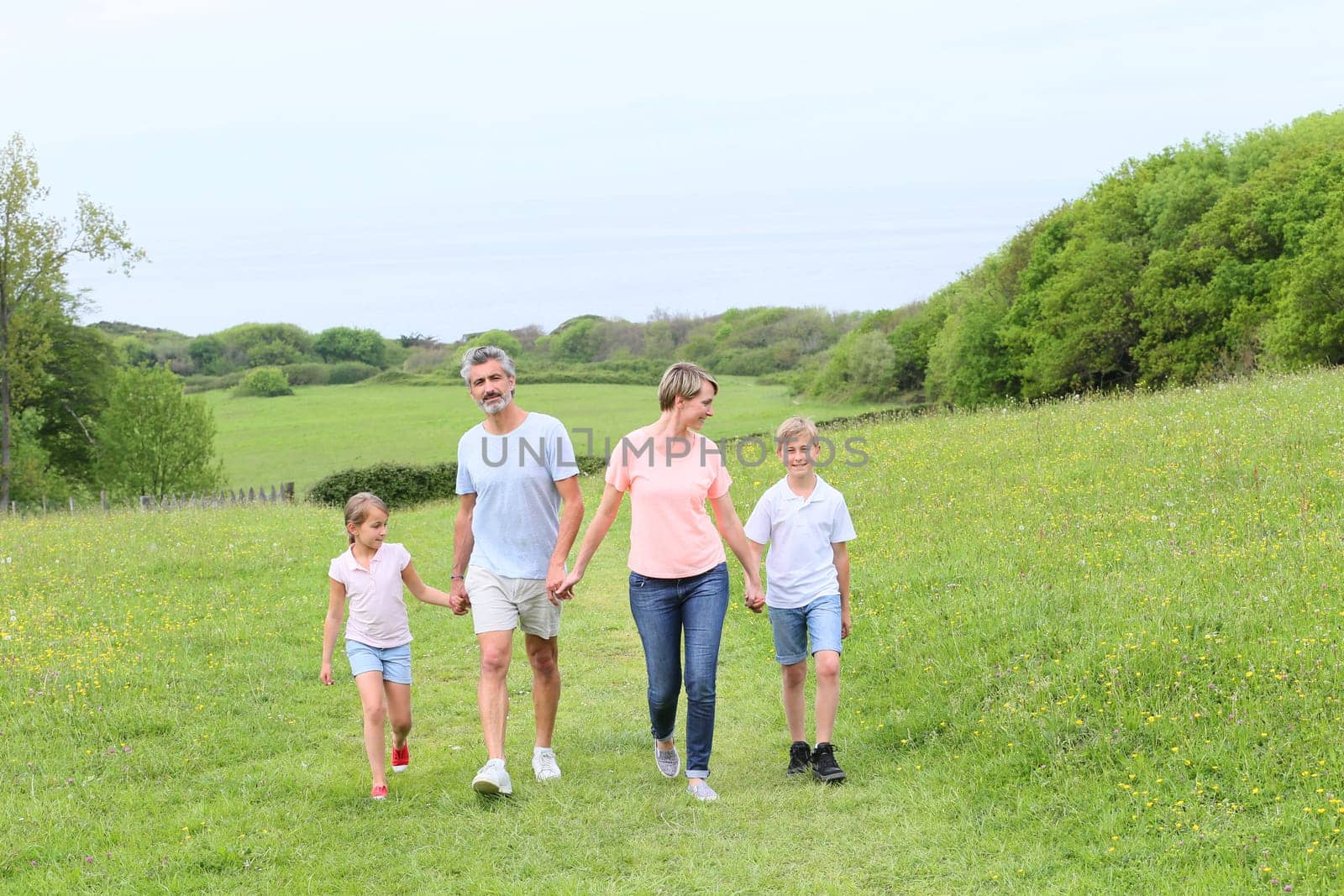 Family walking on country trail during vacation time