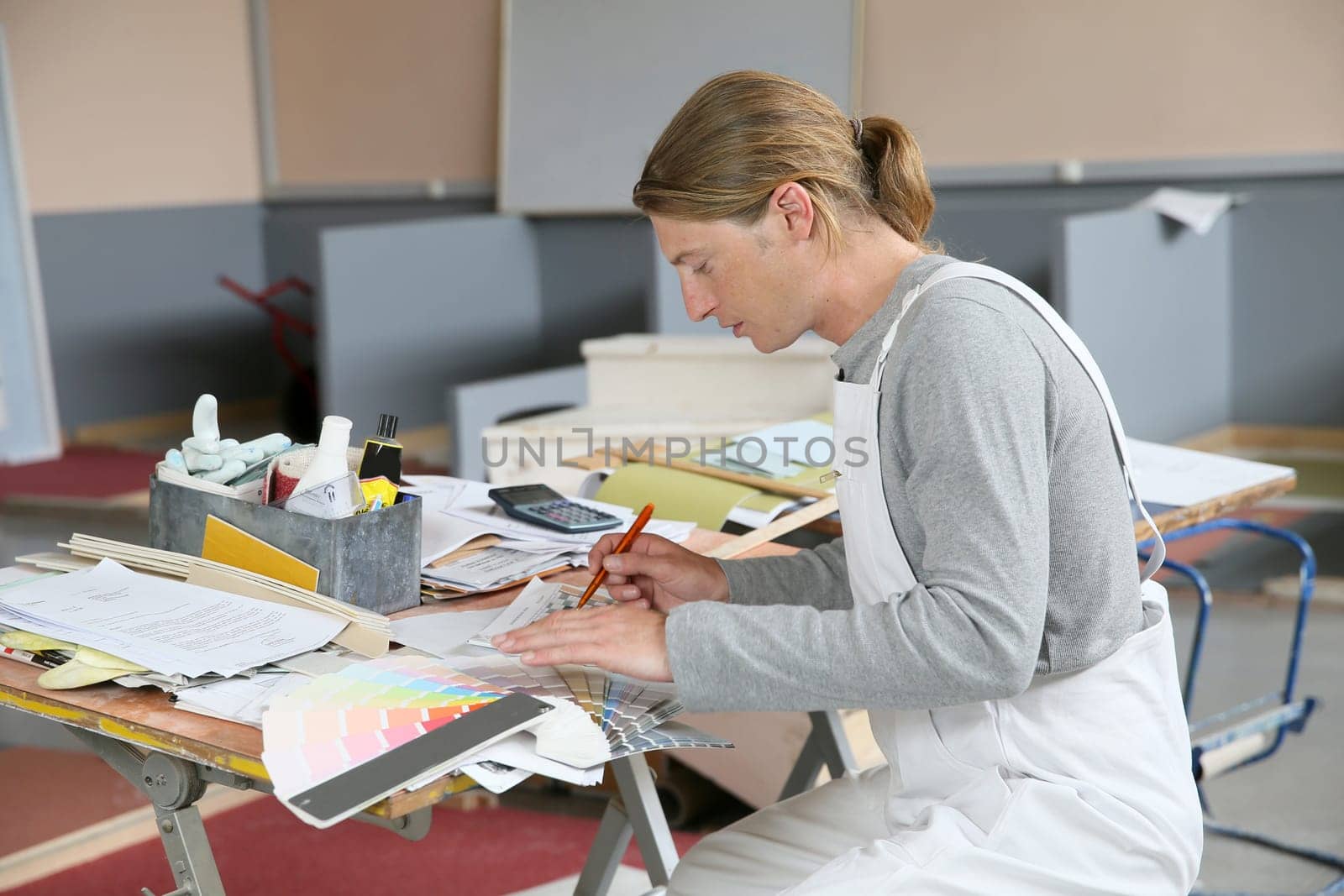 House painter preparing colour sample for house painting