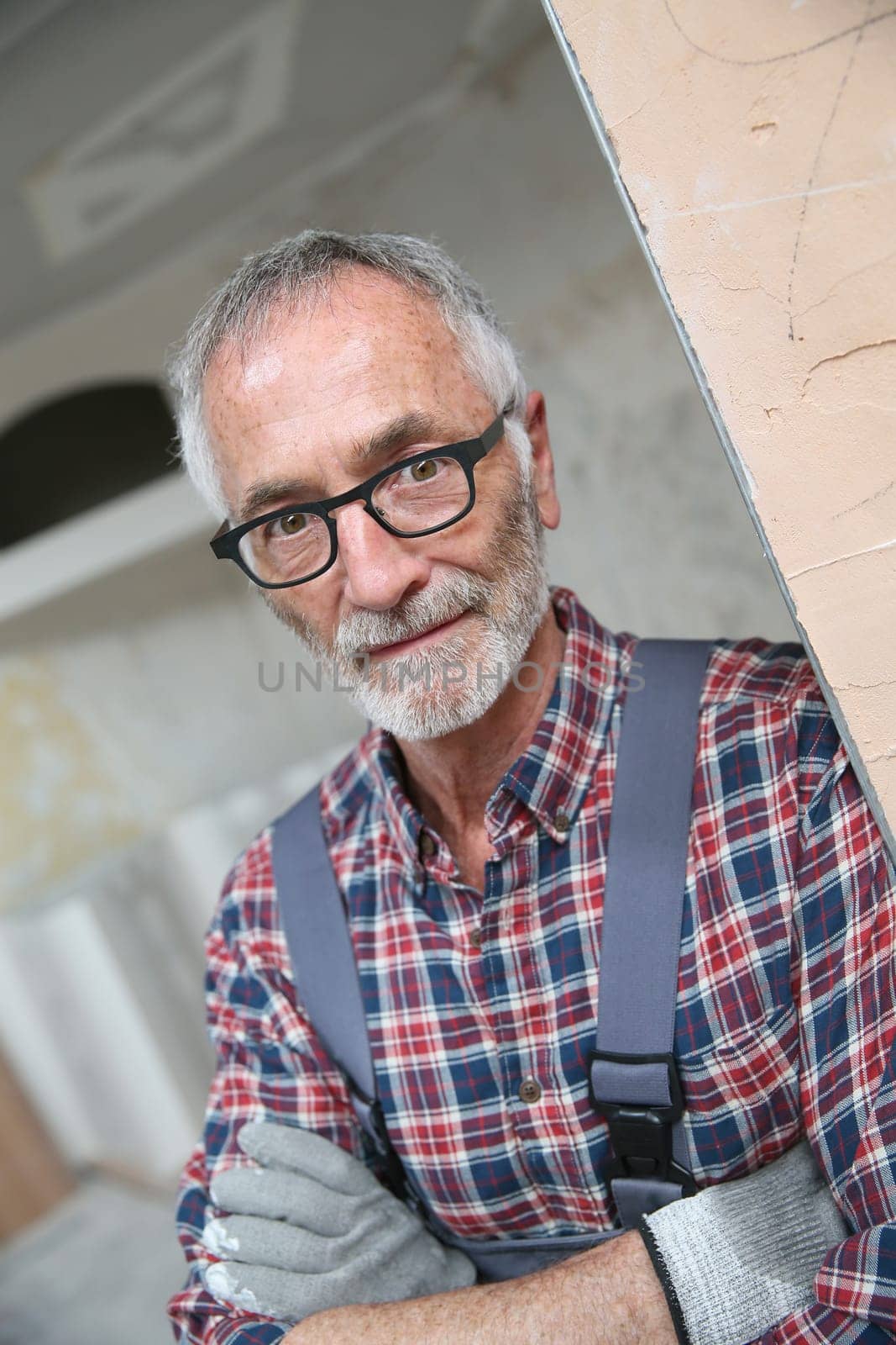 Portrait of senior craftsman in construction looking at camera