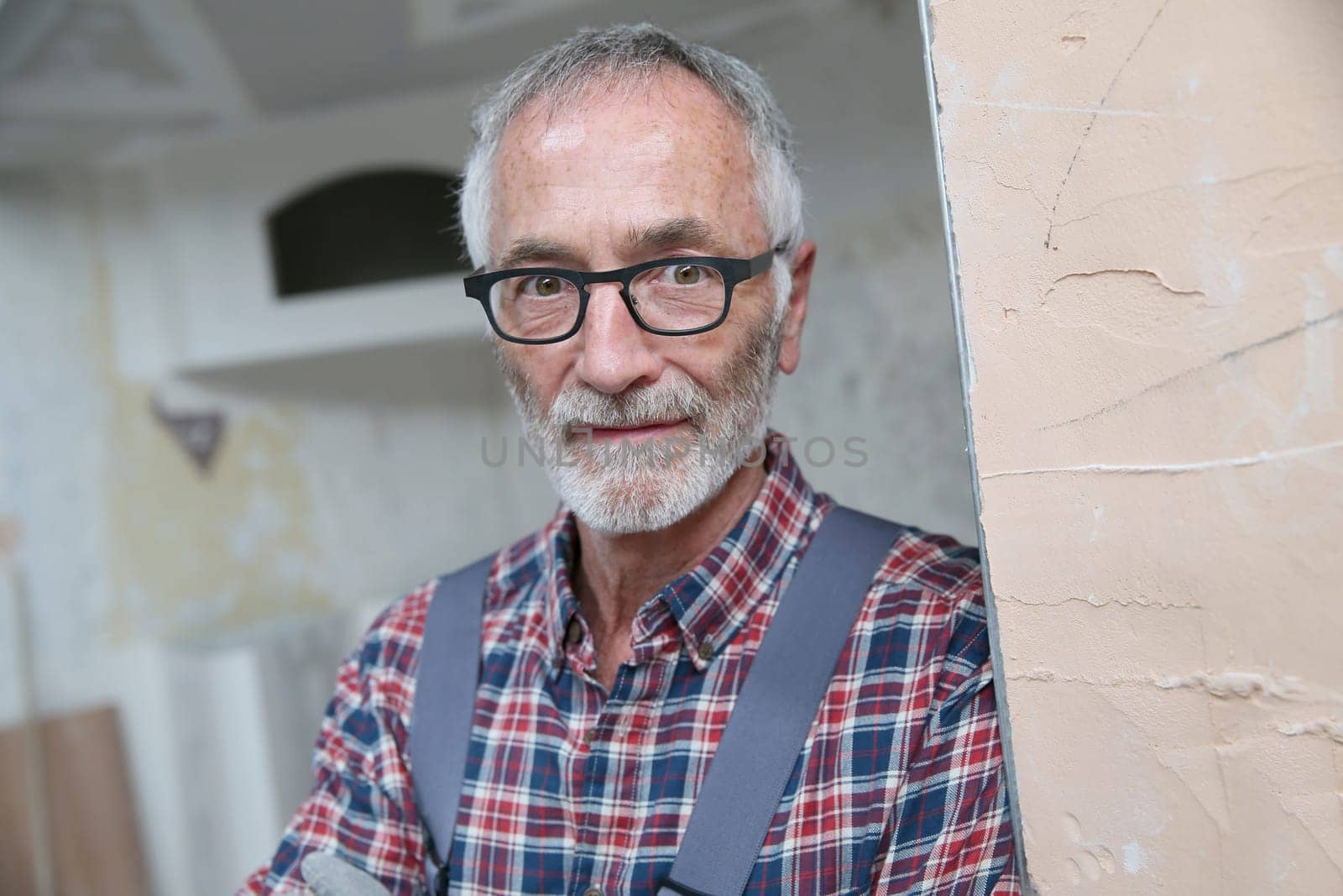 Portrait of senior craftsman in construction looking at camera