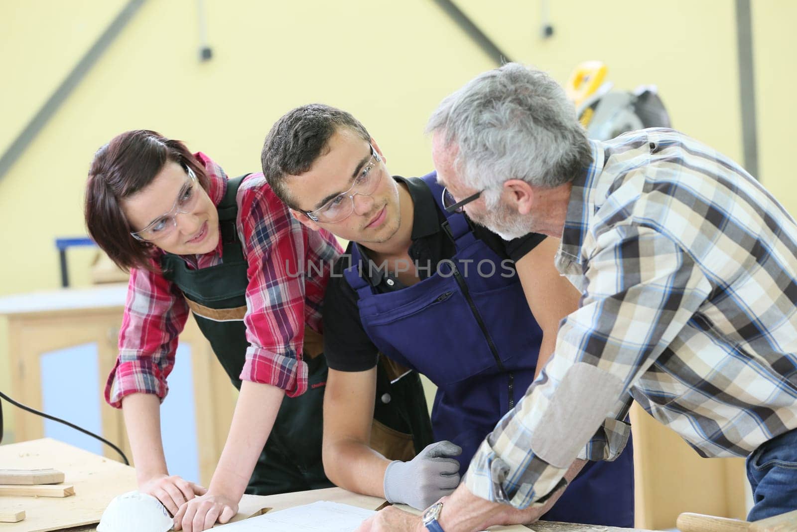 Young people in carpentry course with teacher