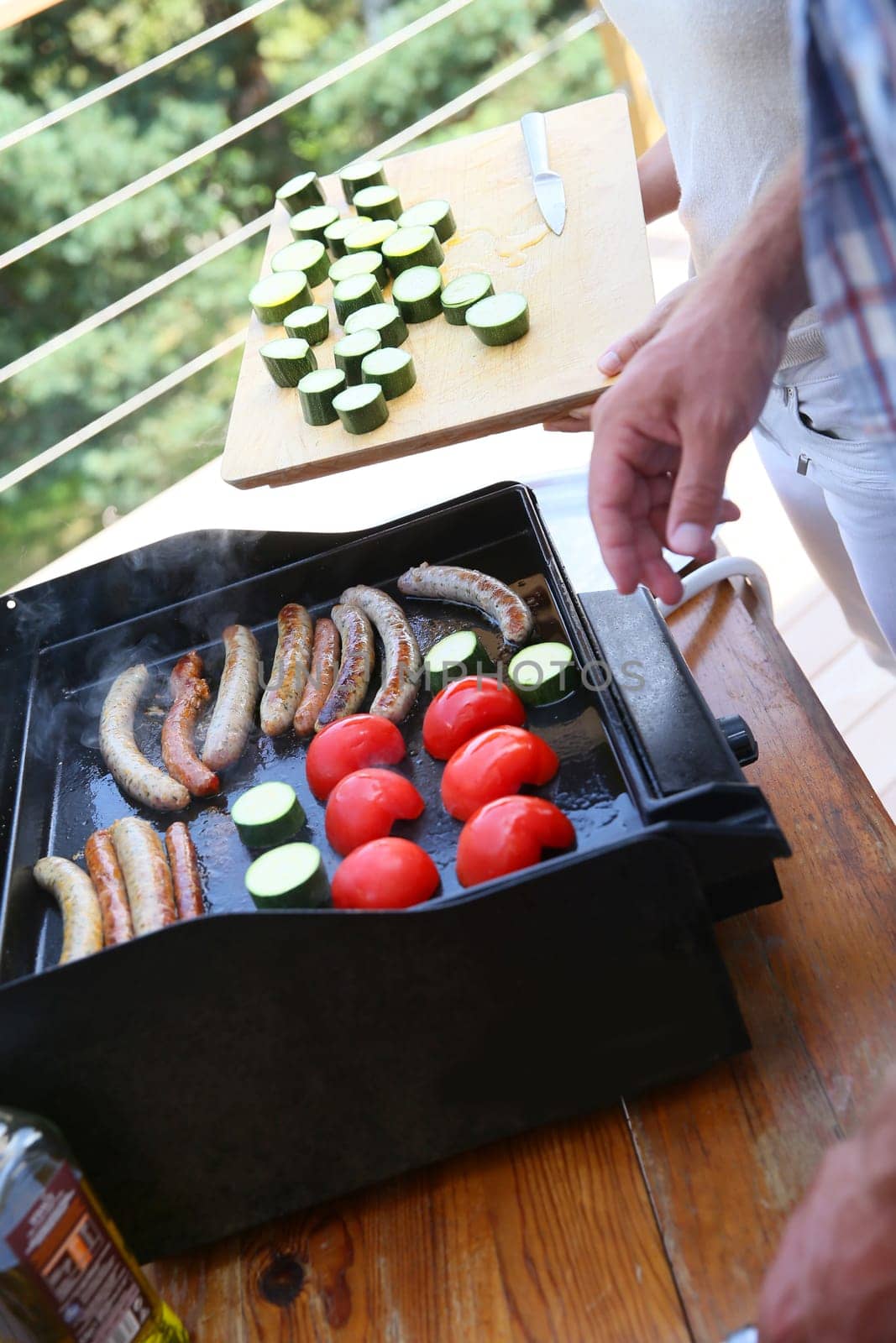 Closeup of man cooking grilled meat on barbecue