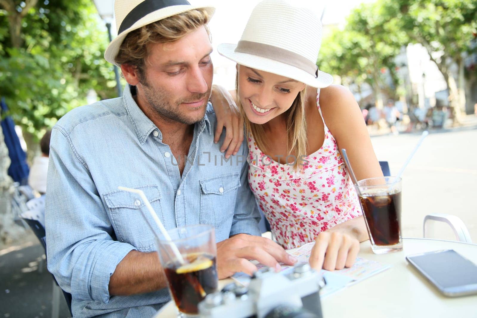 Couple of tourists having a drink in town