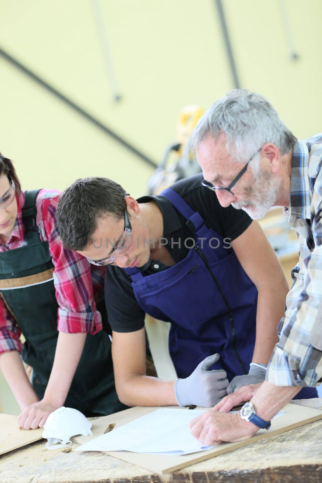 Young people in carpentry course with teacher