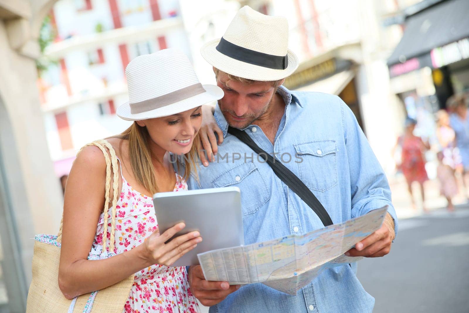 Couple in vacation looking at tourist guide on internet