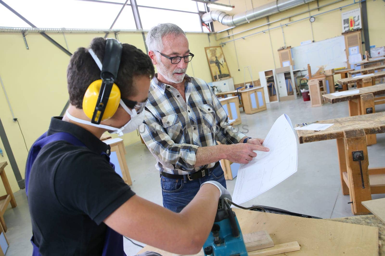 Carpenter with apprentice in training period