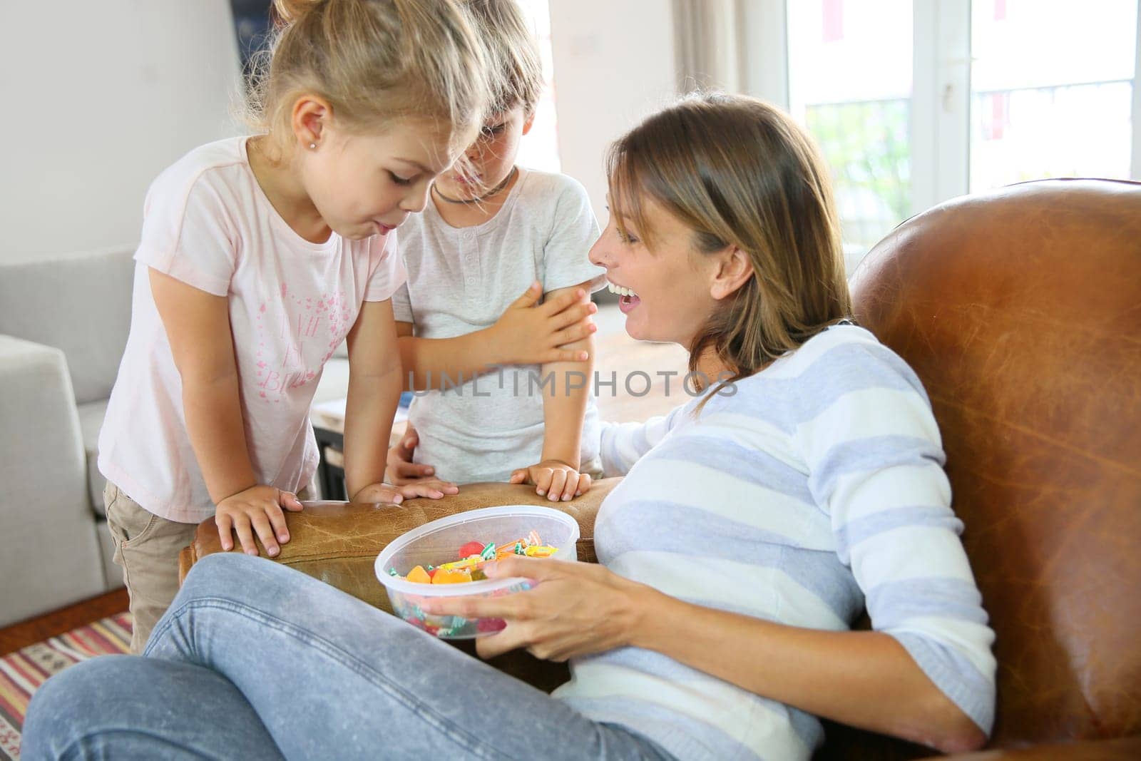 Kids getting candies from their mom