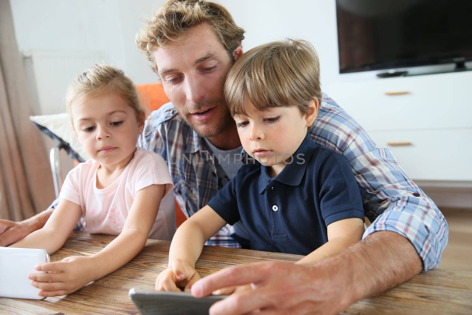 Daddy with kids playing with smartphone