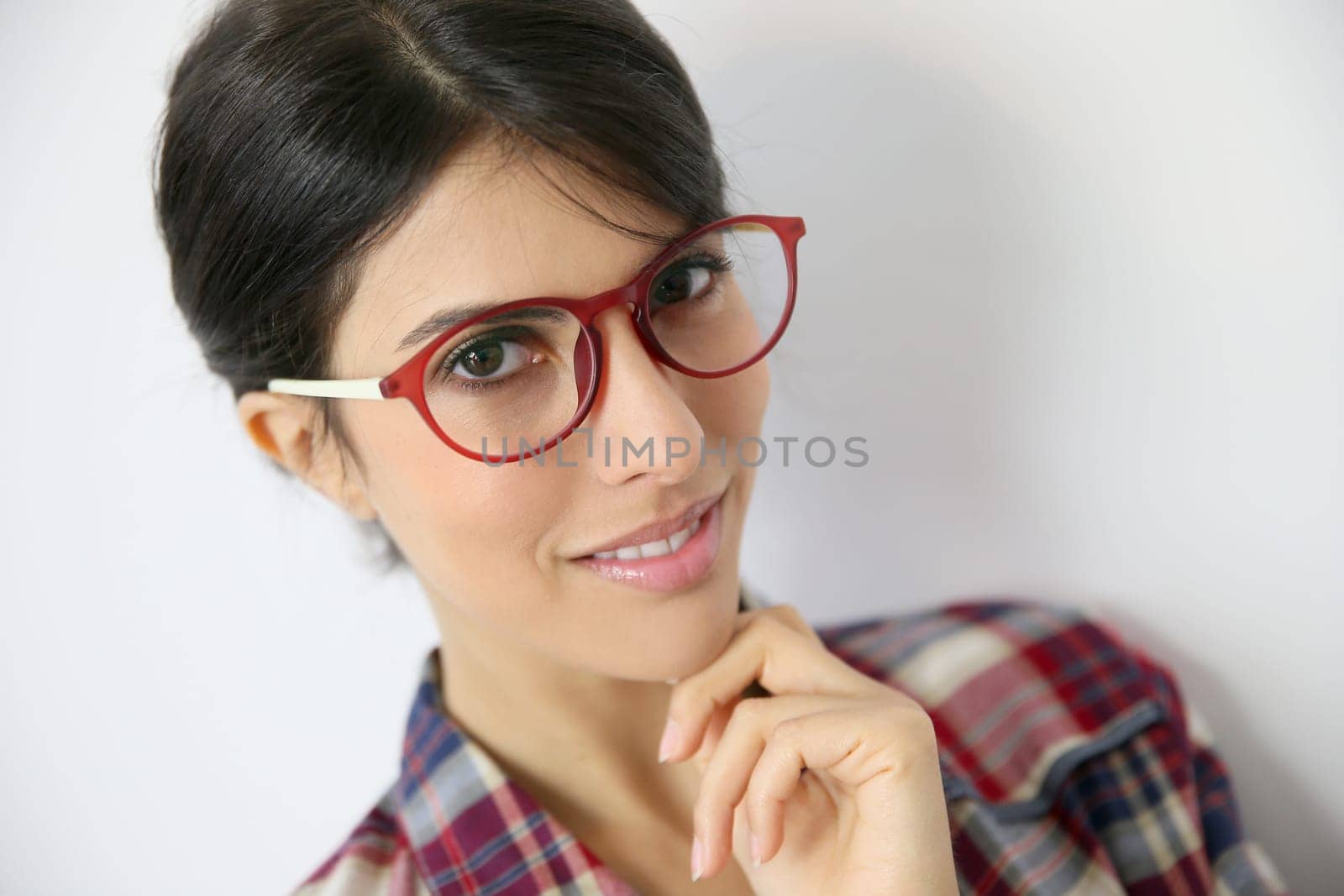 Portrait of brunette girl with red eyeglasses on, isolated