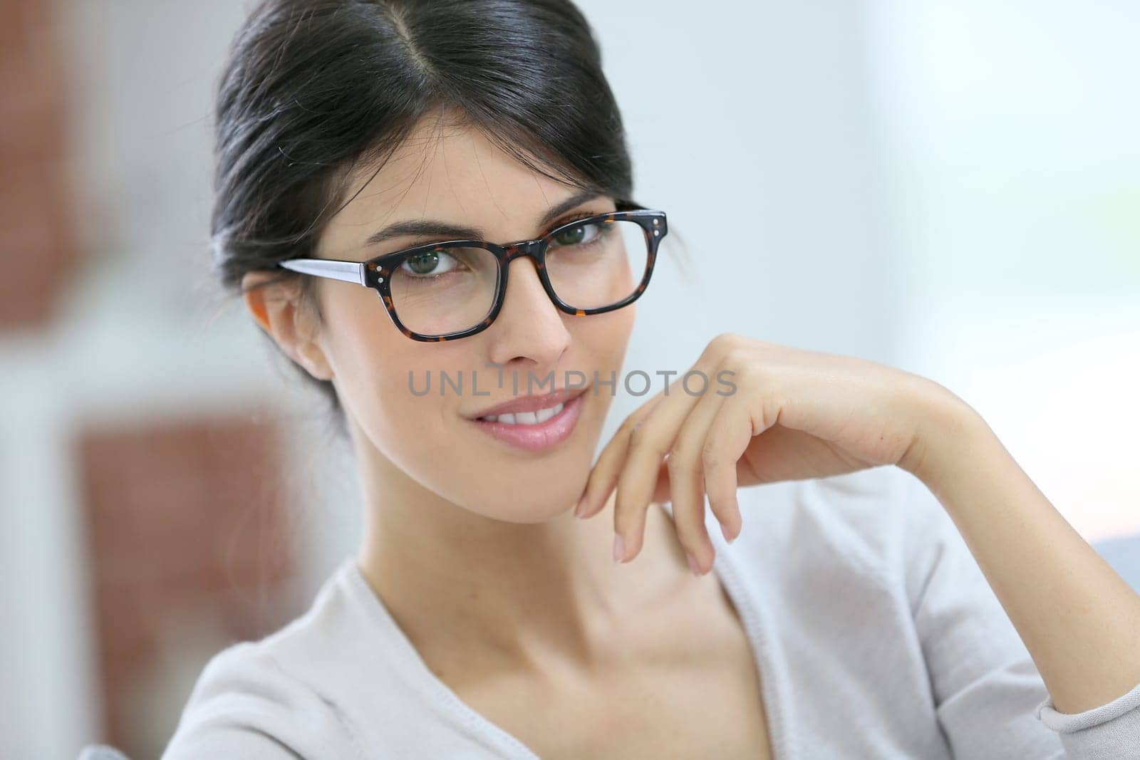 Portrait of beautiful young woman with eyeglasses on