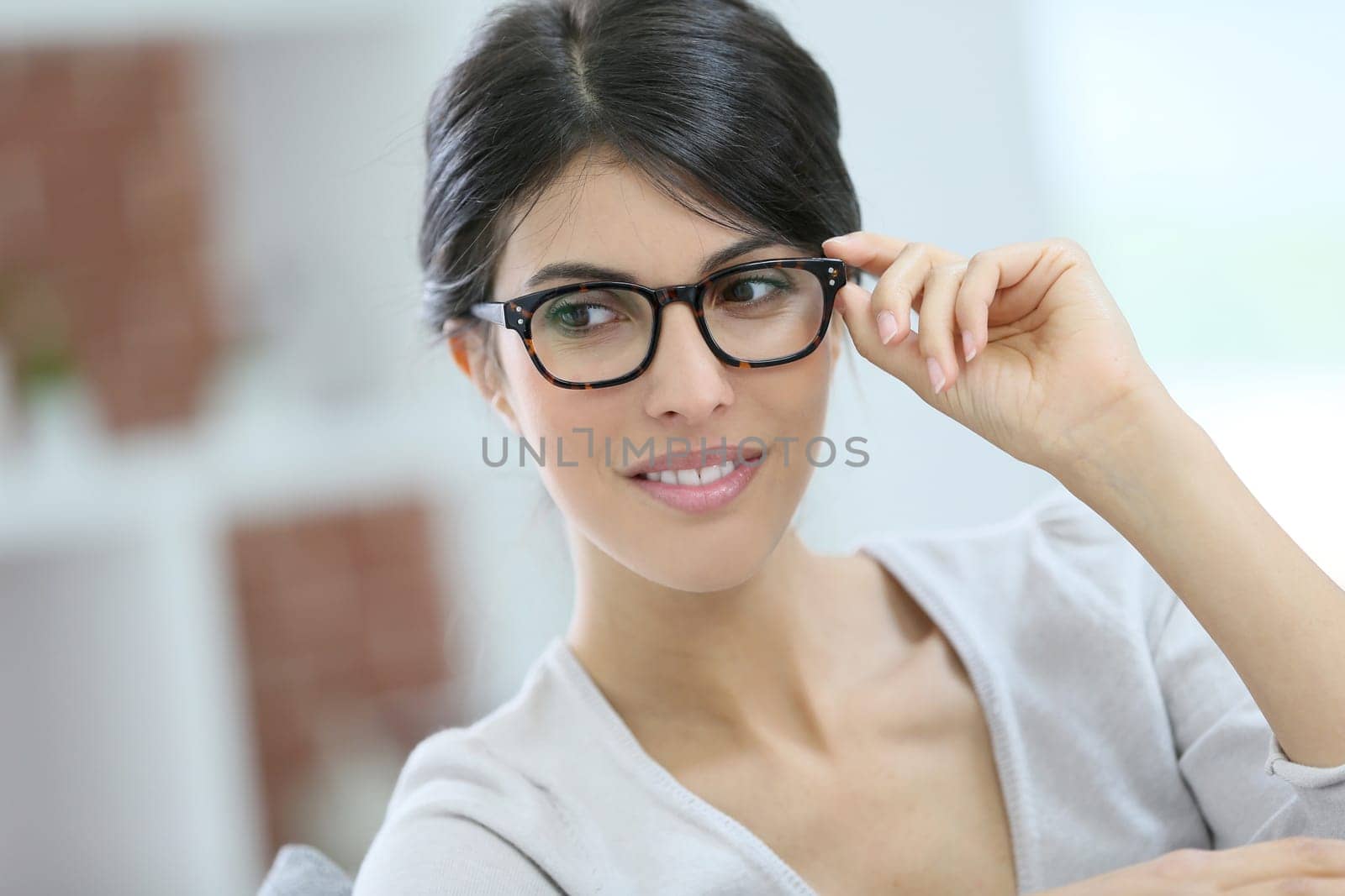Portrait of beautiful young woman with eyeglasses on