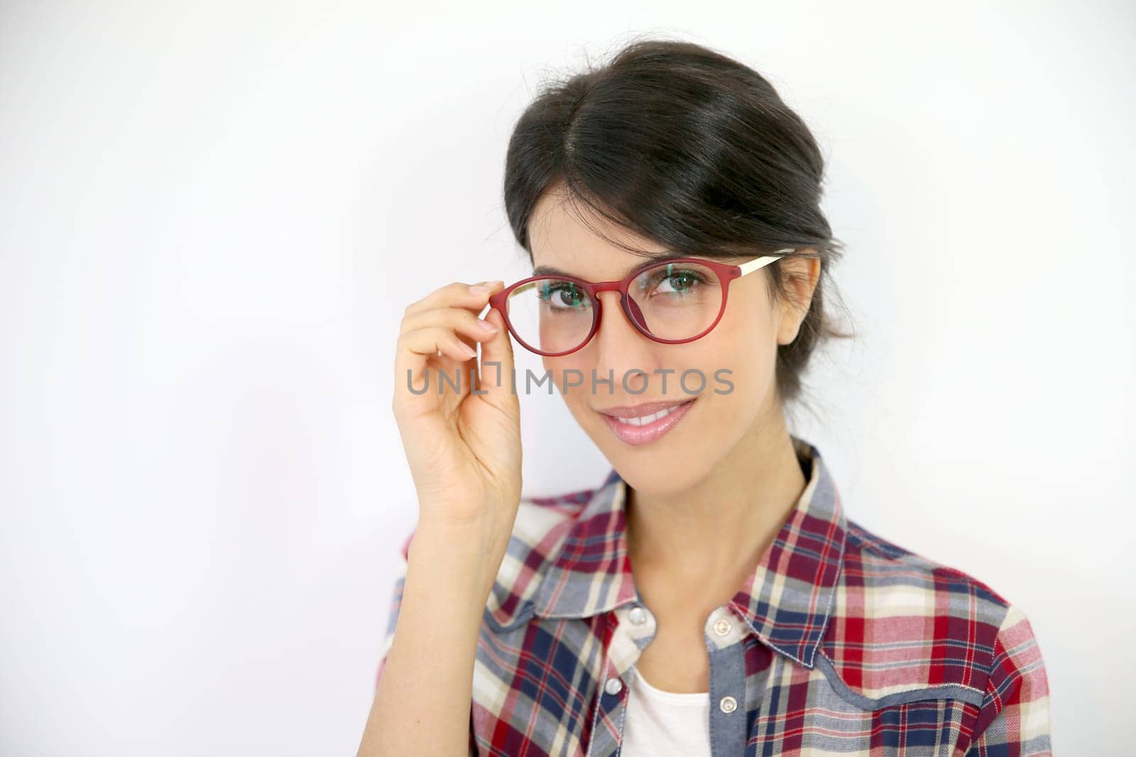 Portrait of brunette girl with red eyeglasses on, isolated