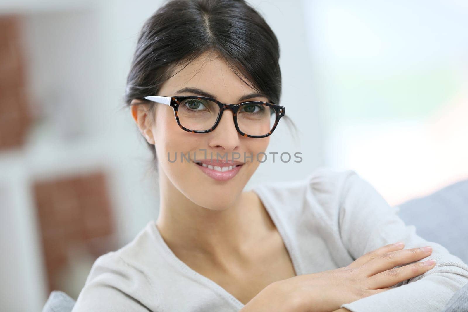 Portrait of beautiful young woman with eyeglasses on
