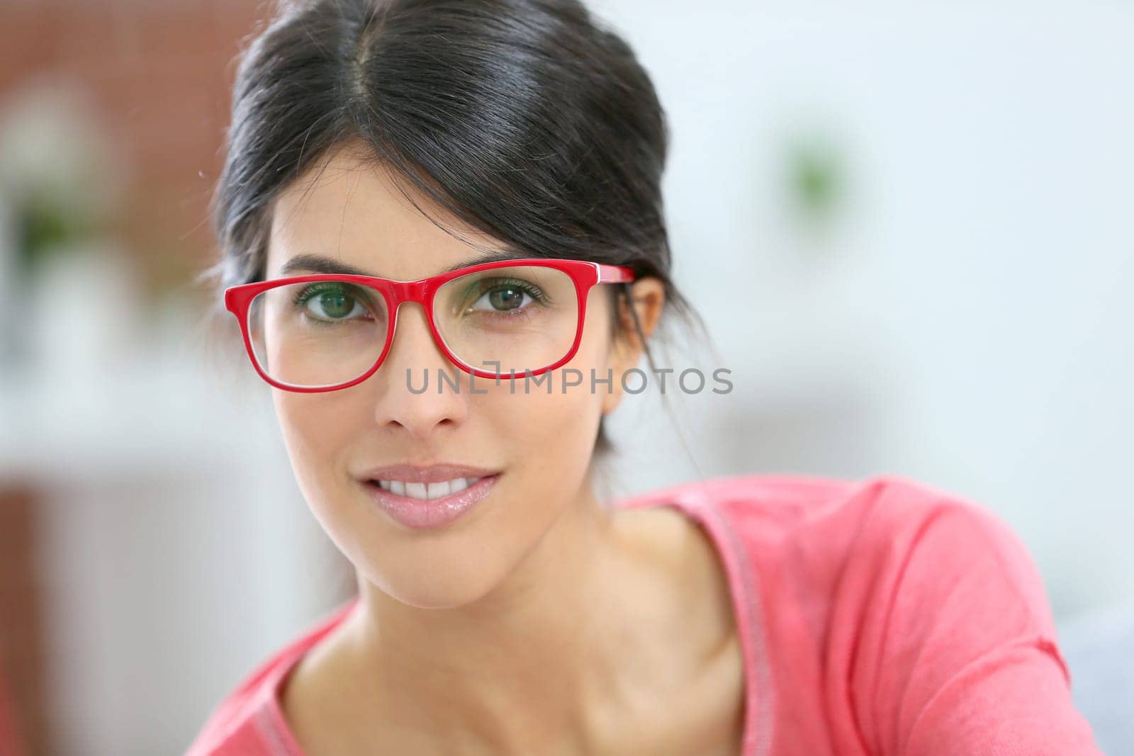 Portrait of beautiful brunette girl wearing red eyeglasses