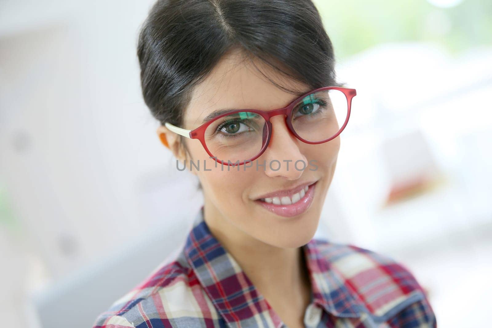 Portrait of brunette girl with red eyeglasses on, isolated