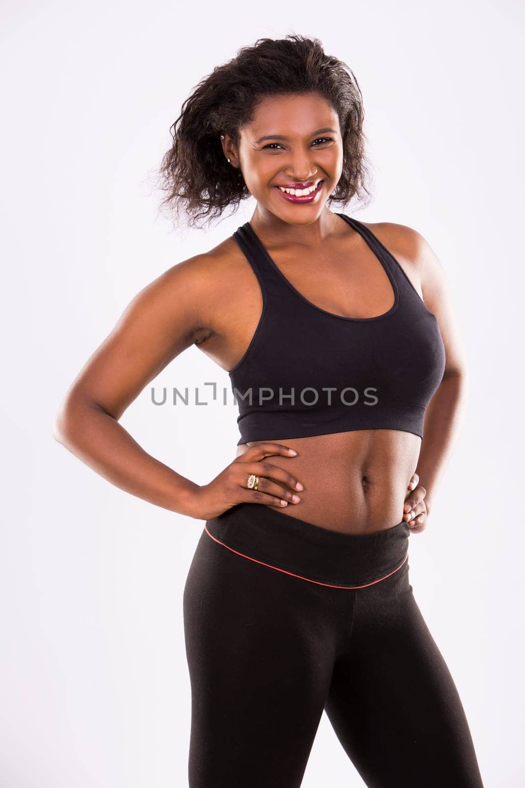 young black woman wearing fitness outfit on white isolated background