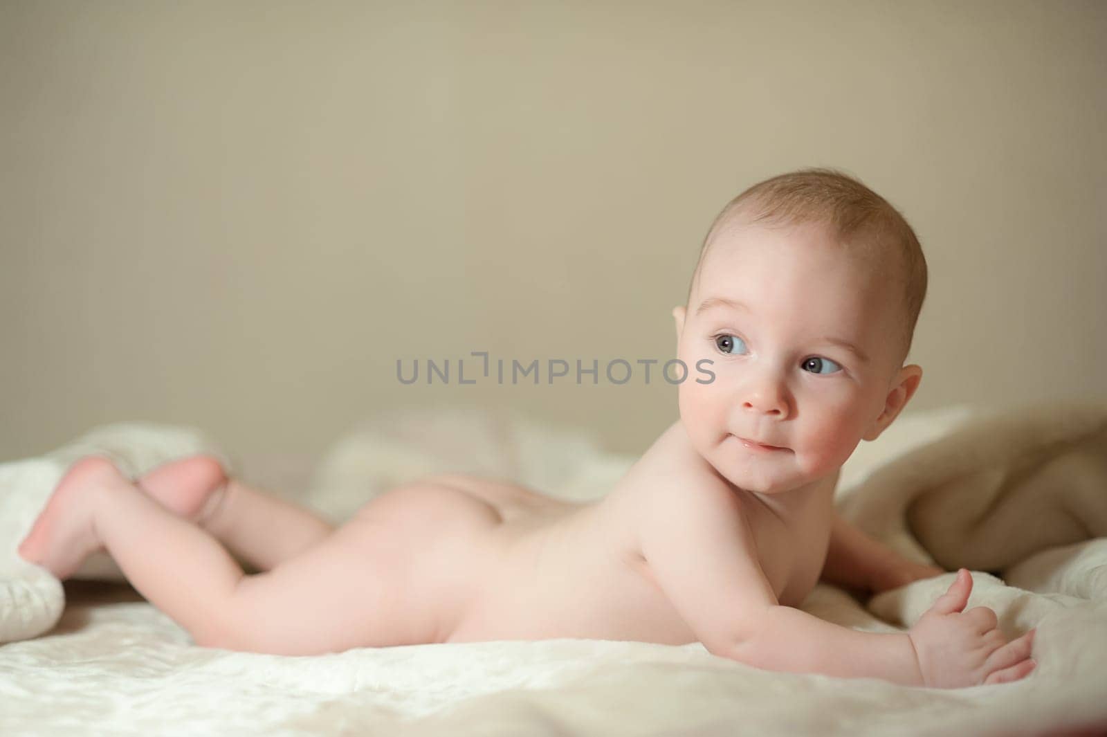 The little boy newborn baby smiling and drooling creeps and lies, Sleeps