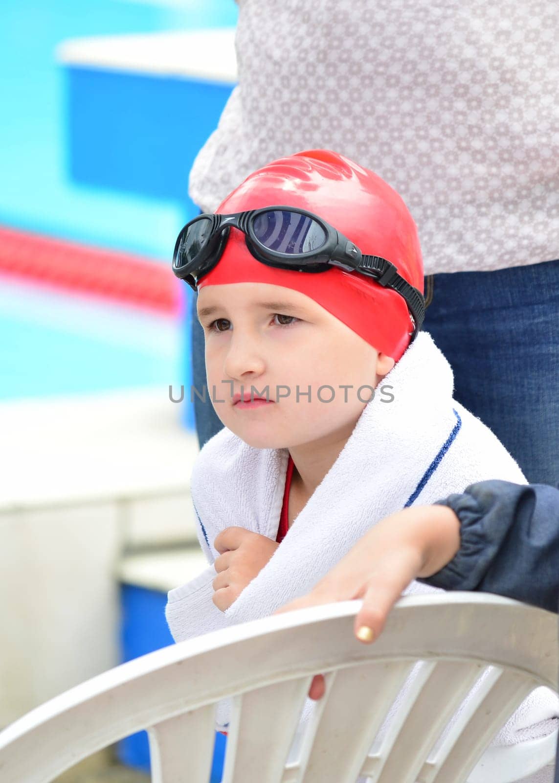 Swimmer with swimming cap and goggles waiting for her start